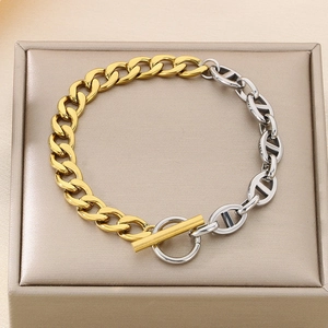 Detail of two-tone gold and silver link bracelet with T-bar clasp and pig-nose chain
