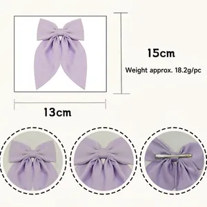 Large handmade purple satin bow hair clip with multi-layer fabric and spring clip design