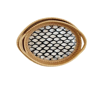 Handwoven rattan oval trays with seashell inlay patterns and dual handles for home storage