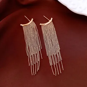 Elegant rose gold tassel earrings with multi-layer bead chains on a silky background