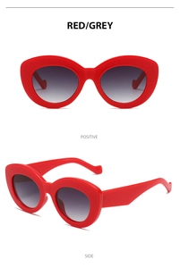 Detail view of red and grey y2k retro oval sunglasses showing front and side angles
