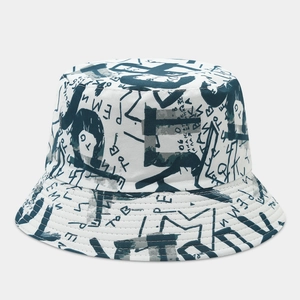 Close-up of graffiti lettering and abstract print on white canvas bucket hat detail