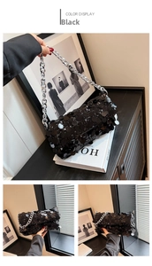 Detail view of the black sequin handbag with thick silver chain and flap closure