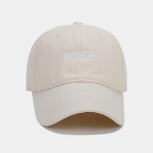 Close-up of PARIS embroidery on beige twill cotton baseball cap with classic visor