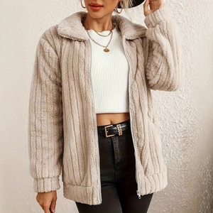 Detail of beige teddy fleece jacket showing soft texture and zipper closure for women