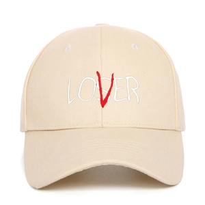Detail view of the LOSER LOVER embroidery on a beige cotton twill baseball cap
