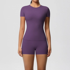 Detail of slim fit dark purple sports set with crew neck tee and high stretch shorts