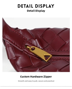 Close-up of luxury burgundy woven leather bag with designer gold triangle zipper detail