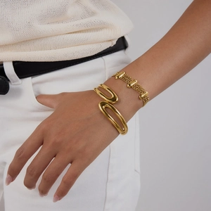 Polished 18K gold-plated double-layer open bangle and beaded chain bracelet on model