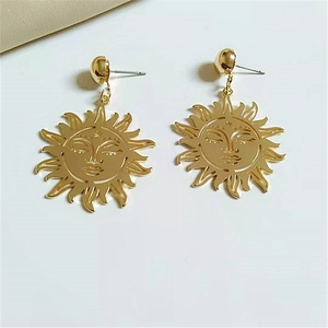 Gold oversized sun face drop earrings in a trendy metallic design for women