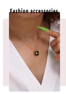 Close-up of starburst pendant necklace with black acrylic and sparkling stone detail