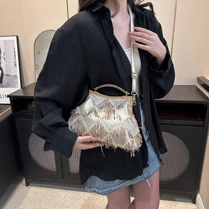 Champagne gold vintage shell bag with sequins and bead tassels shown with crossbody strap
