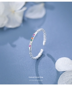 Macro view of S925 silver ring featuring five small colorful rainbow zirconia stones