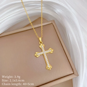 Detail of gold cross pendant with micro-inlaid stones on a jewelry display case