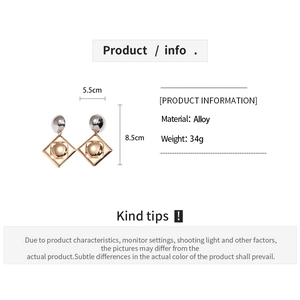 Detail shot of oversized geometric alloy earrings showing size dimensions and 34g weight