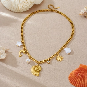 Gold Cuban chain necklace with shell, dolphin, sun pendants and pearls on a beach background