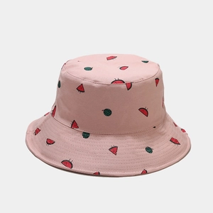 Close-up of pink cotton bucket hat with cute watermelon embroidery and canvas texture