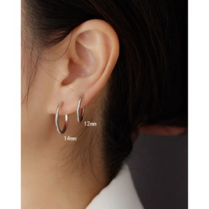 Detail view of 12mm and 14mm S925 sterling silver hoop earrings on model ear