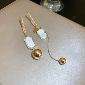 Detail of emerald leaf drop earrings with long gold tassels and diamond inlay