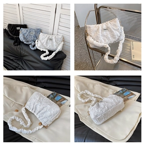 Detail of pleated cloud bags in black, white and floral blue with elegant chain straps