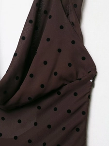 Detail of brown fabric with black polka dots and a high-quality invisible zipper closure
