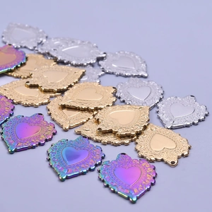 Vintage heart pendants in gold, silver, and rainbow colors with embossed floral patterns