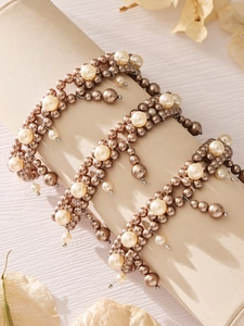 Detail of elegant champagne pearl bracelet wrapped on a luxury velvet display roll