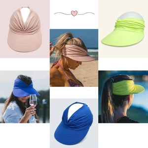 Detail view of pleated sun visor hat in pink, yellow, and blue colors on models