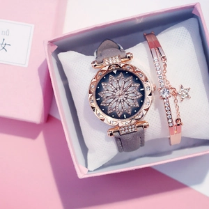Detail of rose gold watch with rhinestone bezel and matching star charm bracelet set