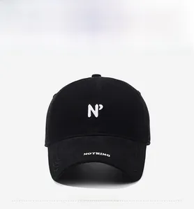 Detail of embroidered N° symbol and NOTHING text on black washed cotton baseball cap