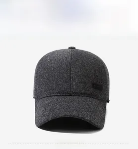 Detailed view of dark grey baseball cap with textured tweed fabric and SPORT label