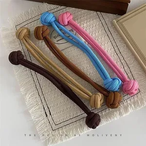 Detailed view of elastic knitted hair ties with ball knots in four vibrant assorted colors