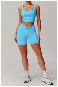 Detail of sky blue sports vest and V-shaped crossover high waist fitness shorts set