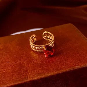 Vintage gold open ring with large oval red zircon and intricate hollow texture