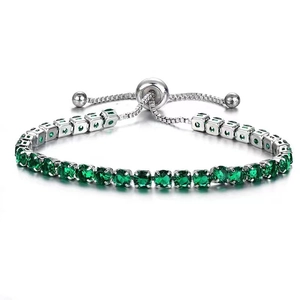Detail showing the adjustable slide buckle and round faceted green gemstones on the bracelet