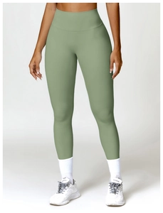 Close-up of high-waisted seamless yoga leggings in sage green with smooth fabric texture