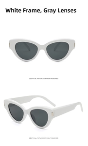 Detailed side view of white cat-eye sunglasses with gray lenses and metal temple accents