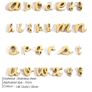 Macro shot of 7mm 14K gold stainless steel lowercase letter pendants in a matrix layout