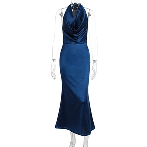 Detail of the navy blue satin halter neck dress showing the draped V-neckline texture