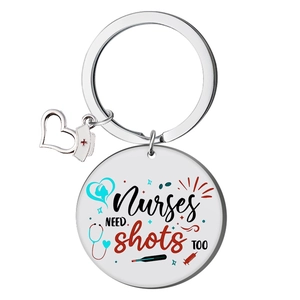 Detail of silver nurse keychain with heart hat charm and creative medical print engraving