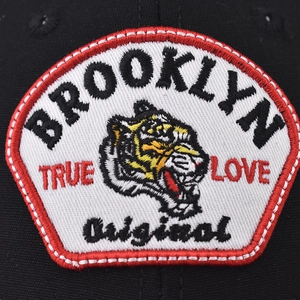 Brooklyn embroidered baseball cap featuring a detailed tiger patch on black mesh fabric