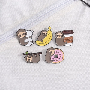 Set of 5 cute sloth enamel pins featuring banana and donut designs on white canvas bag