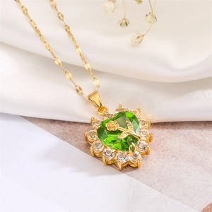 Detail of green heart pendant with gold rose embossing and zircon halo on gold chain
