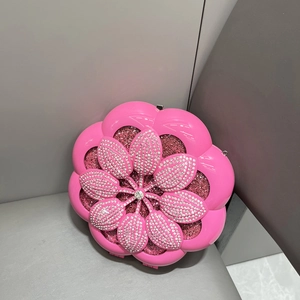 Macro detail of rose pink floral evening clutch bag with sparkling white crystal inlay