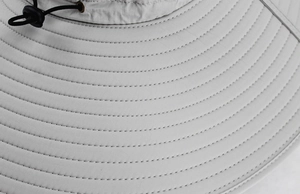 Detail of wide brim outdoor sun hat showing reinforced stitching and adjustable drawstring