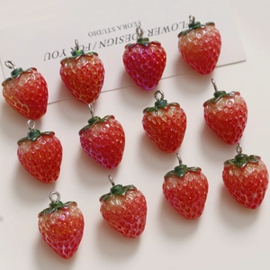 Detailed macro view of 3D resin strawberry charms with metallic silver hanging rings