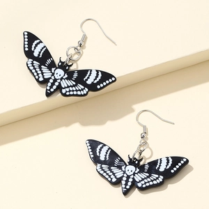 Death's-head hawk moth earrings with skull patterns on white and black acrylic wings