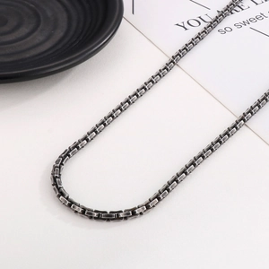 Detail of silver stainless steel box chain necklace with vintage matte finish