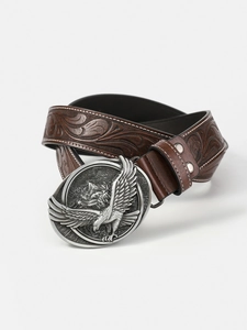 Detail of vintage brown leather belt with eagle buckle and embossed leaf pattern texture