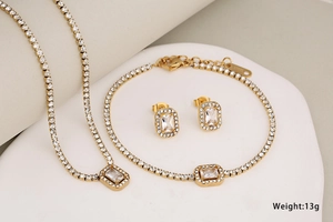 Detailed view of 13g gold stainless steel jewelry set with sparkling square crystals